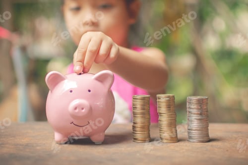 Preview: cute little girl holding coin of money and put in pink piggy bank.