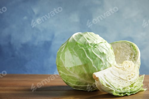 Preview: Whole and sliced cabbages on wooden table