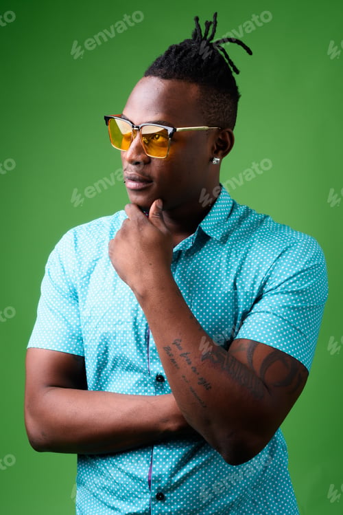 Preview: Young handsome African man from Kenya against green background