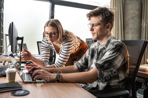 Preview: Programmers work alongside their colleagues in an office