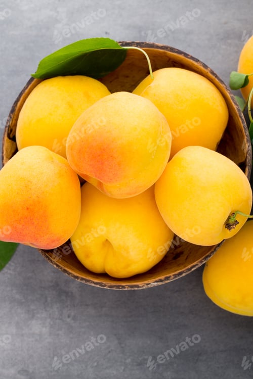 Preview: Apricots with leaves on the old wooden table.