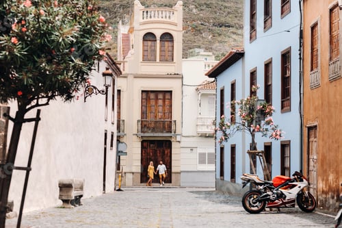 Preview: a modern married couple of lovers strolling in the old town of the island of Tenerife, a couple of
