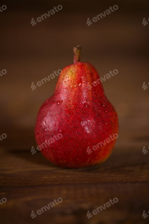 Preview: Pear red color on wooden background.