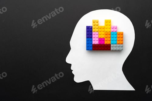 Preview: Papercut silhouette of human head with colorful constructor pieces