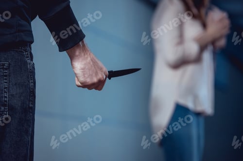 Preview: selective focus of thief with knife standing near woman