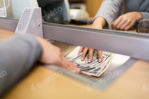 Preview: clerk giving cash money to customer at bank office