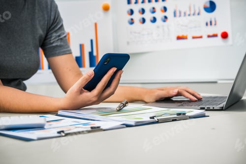 Preview: businesswoman works diligently at her desk, reviewing financial documents and analyzing investment