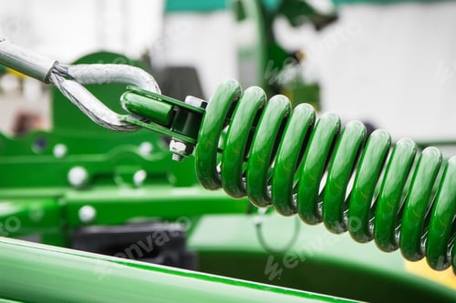 Preview: Green hard spring made of steel. Part of big industrial or agricultural machine