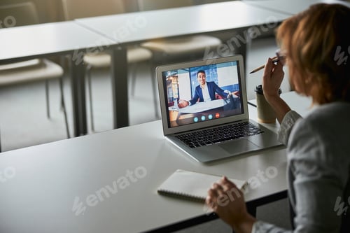 Preview: Woman in Video Conference in Urban Workplace
