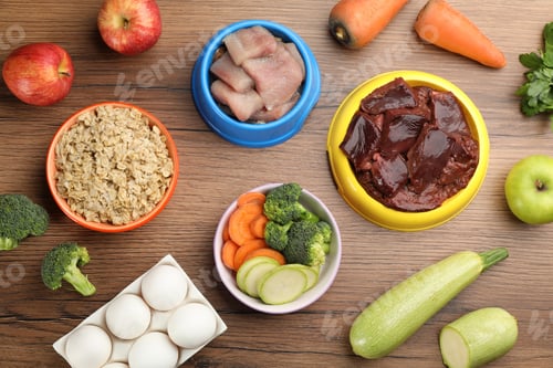 Preview: Pet food and natural ingredients on wooden table, flat lay
