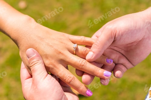 Preview: Hands of two unknown people in a marriage proposal