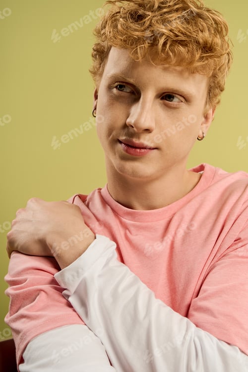 Preview: Handsome young man with stylish hair flaunting trendy outfit in a vibrant setting
