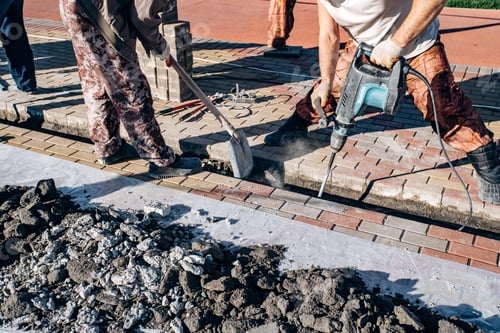 Preview: Workers laid paving slabs. Two workers lay paving slabs.