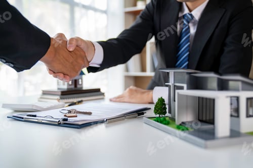 Preview: Real estate agent and customers shaking hands together celebrating finished contract after about hom