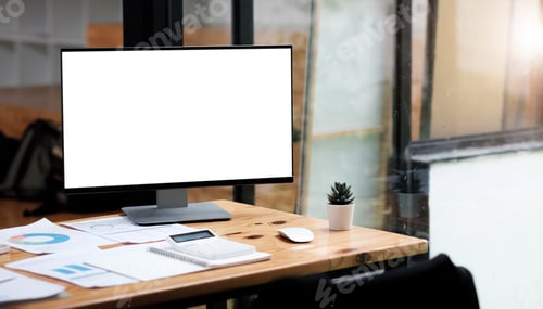 Preview: Computer laptop with white blank screen putting on wooden working desk that surrounded by coffee cup