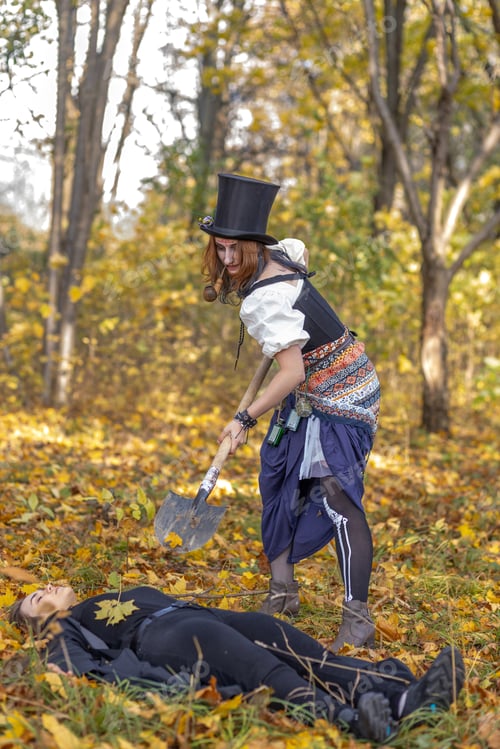 Preview: Portrait of young women in Halloween carnival costume in autumn park.