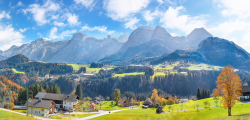 Preview: Alpine green fields and traditional wooden houses near Abtenau village at autumn sunny day.