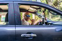 Preview: Man driving a truck making a hang loose gesture