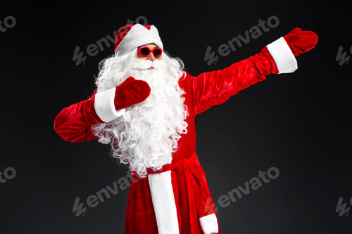 Preview: Funny man wearing Santa Claus costume and stylish sunglasses dancing celebration winter holidays