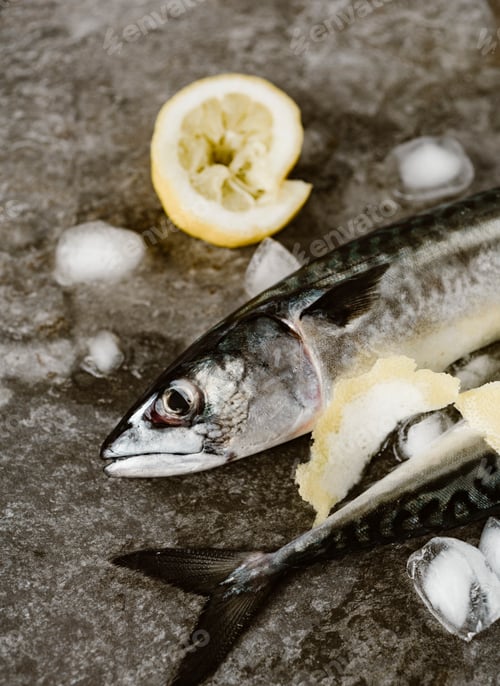 Preview: Fresh fish with delicious chopped seasoning ready for tasty cooking on dark background, top view