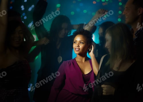 Preview: Shot of a smiling young woman standing on a dance floor in a nightclub surrounded by people