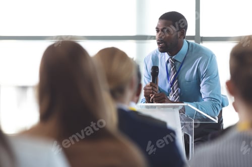 Preview: African-American businessman speaker speaking in a business seminar