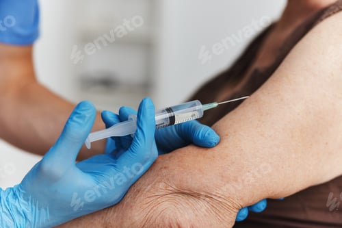 Preview: doctor giving an injection to a woman's hand covid-19 vaccination passport