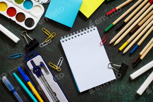 Preview: Back to school background with school supplies, apple on dark concrete or stone background.
