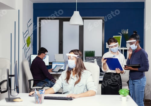 Preview: African and caucasian coworkers cooperating at workplace