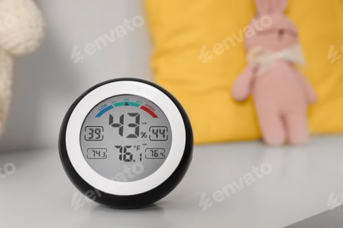 Preview: Digital hygrometer with thermometer on white table. Space for text