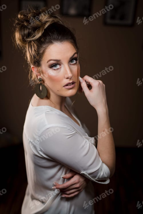 Preview: Beautiful Woman Posing Indoors with Hair in a Bun