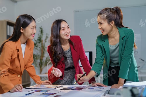 Preview: Three asian businesswomen are having a meeting in the office, analyzing marketing data and discussin