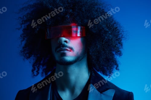 Preview: Fashion portrait of a man with curly hair on a blue background wearing red sunglasses, multinational