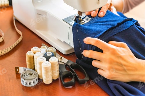 Preview: Dressmaker or seamstress works using sewing machine