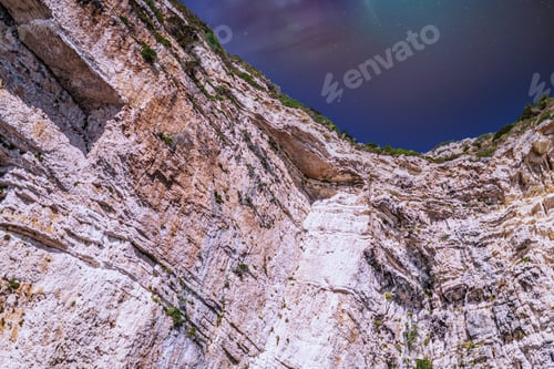 Preview: Northern lights above rocky hills near shore of Corfu island