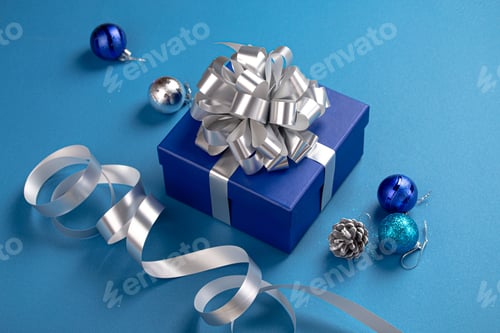 Preview: Christmas composition with present and decorations in blue and silver colors