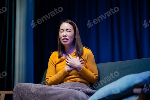 Preview: Female experiencing cardiac distress, gripping chest with visible discomfort and anguish