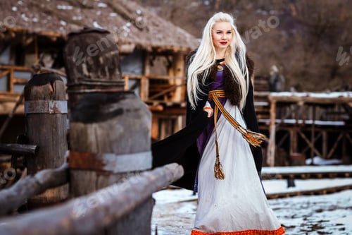 Preview: Beautiful young woman holding a viking with blond hair. Image of Historical figure