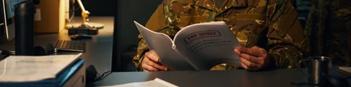Preview: Reviewing Confidential Documents at Office Desk