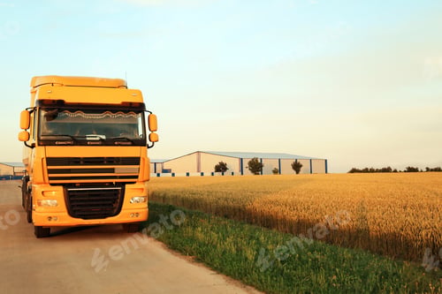 Preview: Modern yellow truck on country road. Space for text