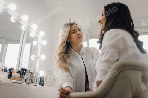 Preview: Makeup artist applying makeup to a client in beauty salon