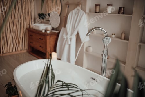 Preview: Luxury interior of big bathroom at modern african style with oval bathtub in natural lighting