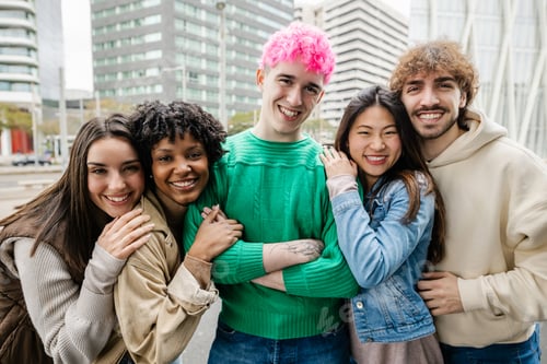 Preview: Millennial diverse friends laughing and hugging in autumn city street