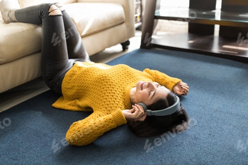 Preview: Woman Lying On Carpet And Listening To Music