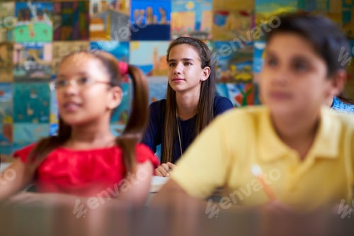 Preview: Smart Girl Listening to Teacher At School