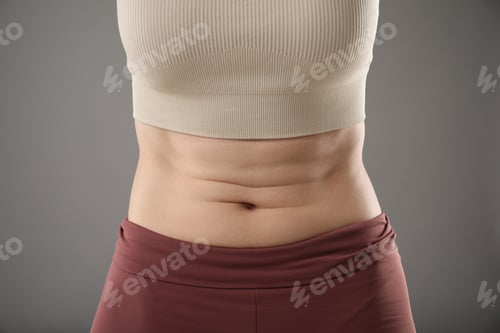 Preview: Woman after weight loss on grey background, closeup