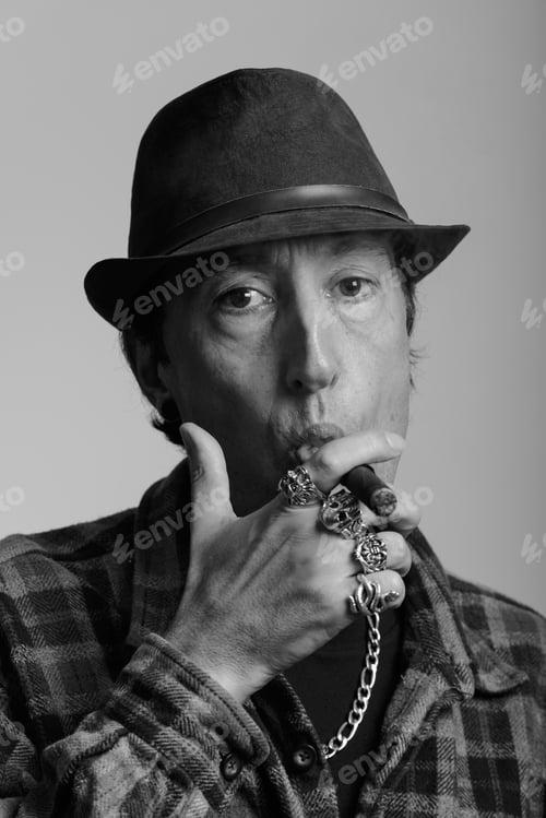 Preview: Face of mature gangster man smoking cigar in black and white
