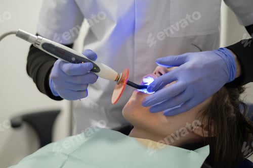 Preview: Dental treatment session in a clinic with a patient receiving care under bright lights