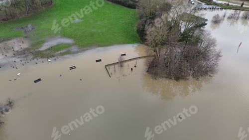 Preview: flooded area with parking lot in the middle of it and several cars
