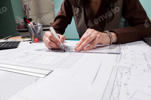 Preview: Close up of architect hands working on blueprints